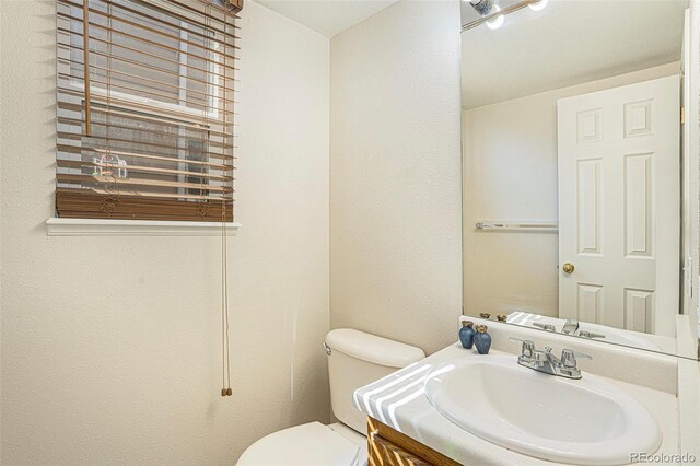 4585 Jet Wing Cir, Colorado Springs, CO 80916 - half bathroom featuring vanity and toilet