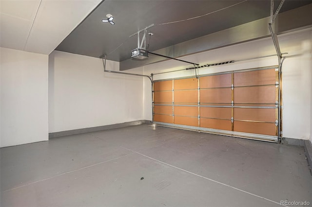 4585 Jet Wing Cir, Colorado Springs, CO 80916 - garage featuring a garage door opener and baseboards