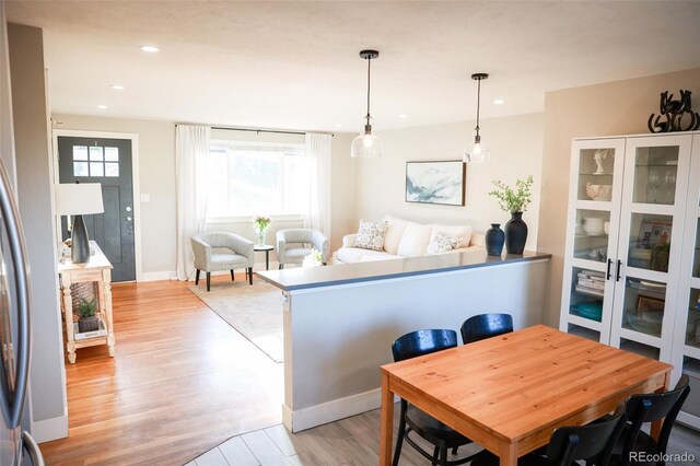 7100 Saulsbury St, Arvada, CO 80003 - dining area featuring light wood-style floors, recessed lighting, and baseboards