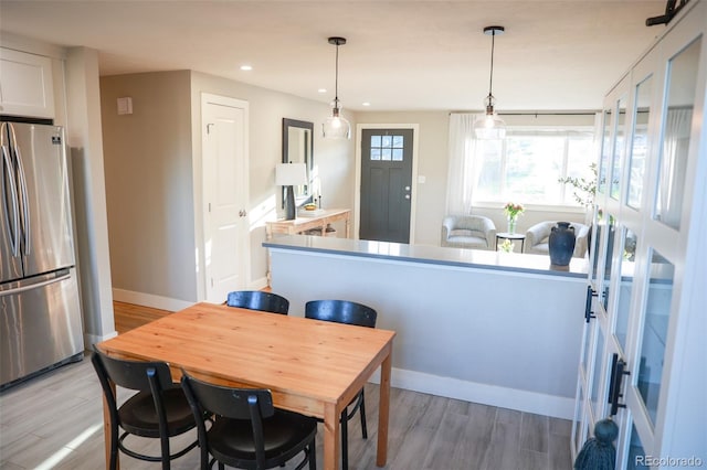 7100 Saulsbury St, Arvada, CO 80003 - dining space featuring light wood-style floors, recessed lighting, and baseboards