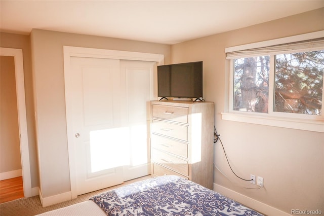 7100 Saulsbury St, Arvada, CO 80003 - bedroom featuring a closet, baseboards, and carpet flooring
