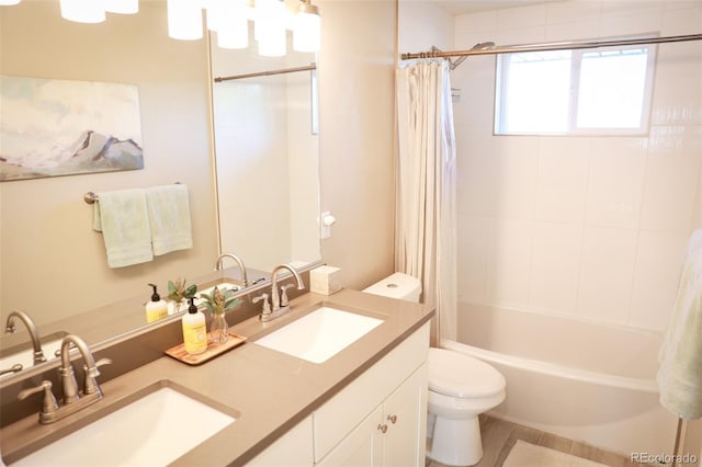 7100 Saulsbury St, Arvada, CO 80003 - bathroom featuring toilet, double vanity, and shower / bath combo