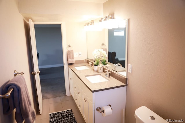 7100 Saulsbury St, Arvada, CO 80003 - bathroom with double vanity, toilet, and tile patterned flooring