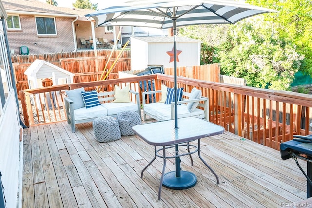 7100 Saulsbury St, Arvada, CO 80003 - wooden deck featuring an outdoor living space