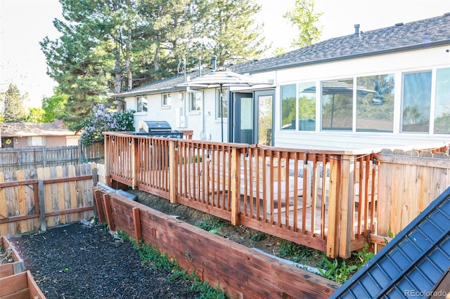 7100 Saulsbury St, Arvada, CO 80003 - wooden terrace featuring area for grilling and a fenced backyard