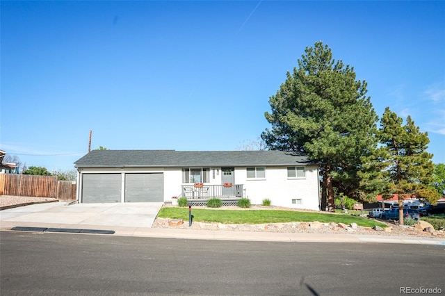 7100 Saulsbury St, Arvada, CO 80003 - ranch-style house with driveway, an attached garage, and covered porch