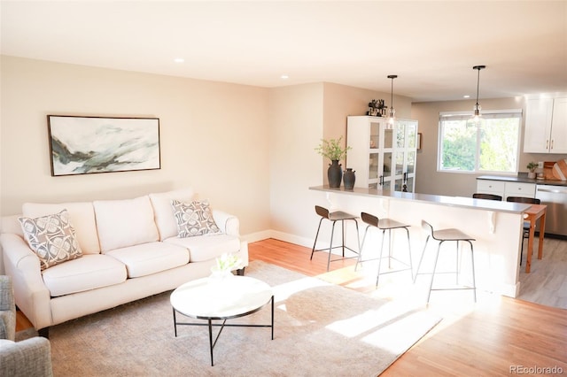 7100 Saulsbury St, Arvada, CO 80003 - living area featuring light wood-style flooring, baseboards, and recessed lighting