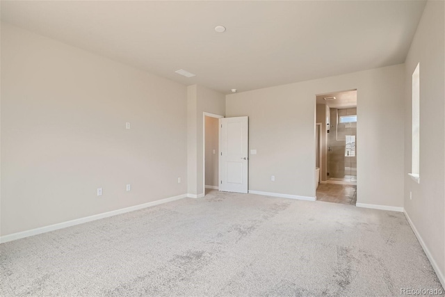 unfurnished room featuring light colored carpet