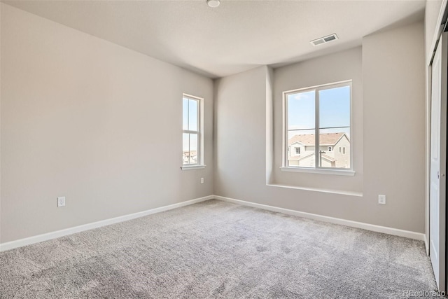 unfurnished room featuring carpet