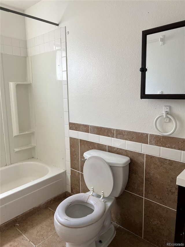 full bathroom with vanity, toilet, tile walls, and bathing tub / shower combination