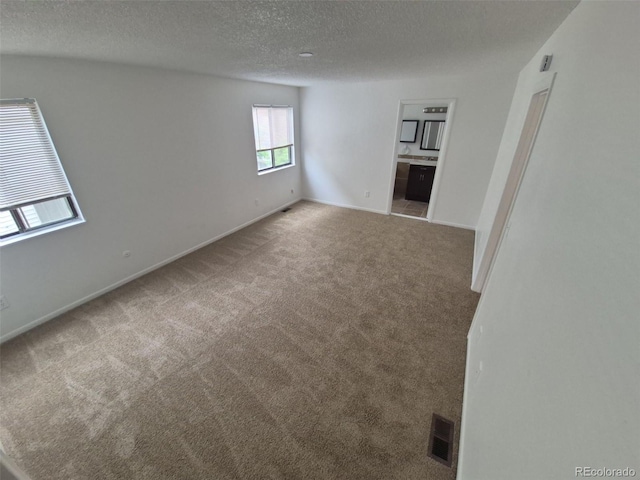 14190 E Gunnison Pl, Aurora, CO 80012 - spare room with carpet floors, a textured ceiling, and baseboards