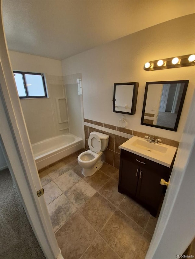 14190 E Gunnison Pl, Aurora, CO 80012 - full bathroom featuring vanity, toilet, tile walls, shower / tub combination, and a wainscoted wall