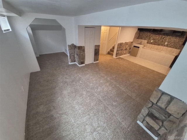 14190 E Gunnison Pl, Aurora, CO 80012 - finished below grade area featuring a fireplace, stairway, carpet flooring, and arched walkways