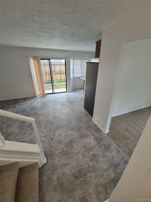 14190 E Gunnison Pl, Aurora, CO 80012 - carpeted spare room featuring a textured ceiling and baseboards