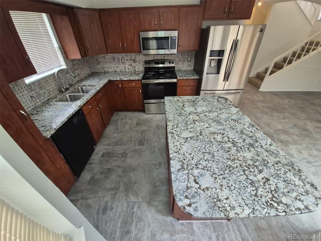 14190 E Gunnison Pl, Aurora, CO 80012 - kitchen with stainless steel appliances, a sink, light stone countertops, and backsplash