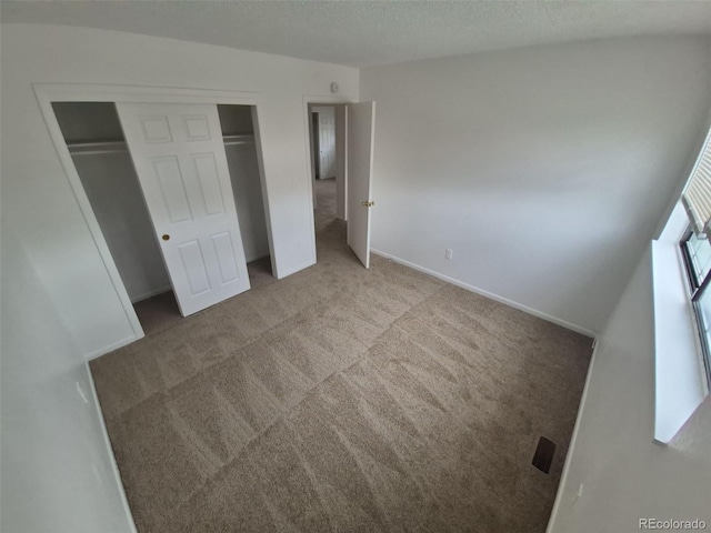 14190 E Gunnison Pl, Aurora, CO 80012 - unfurnished bedroom with a closet, carpet flooring, a textured ceiling, and baseboards