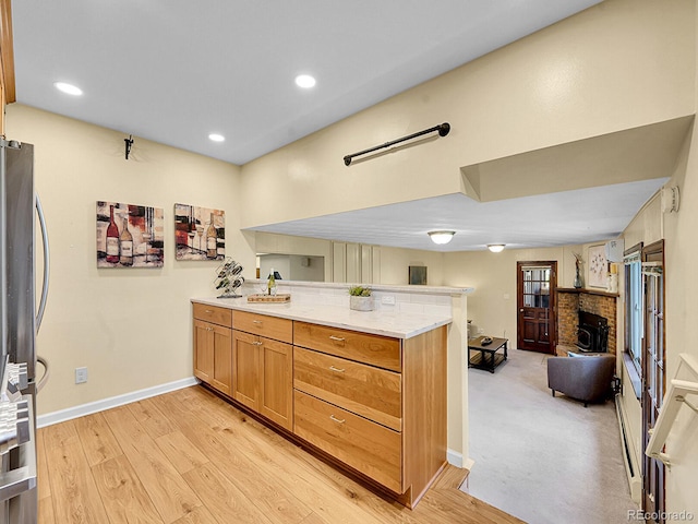 7168 S Lafayette Way, Centennial, CO 80122 - kitchen with a peninsula, open floor plan, freestanding refrigerator, light wood-style flooring, and recessed lighting