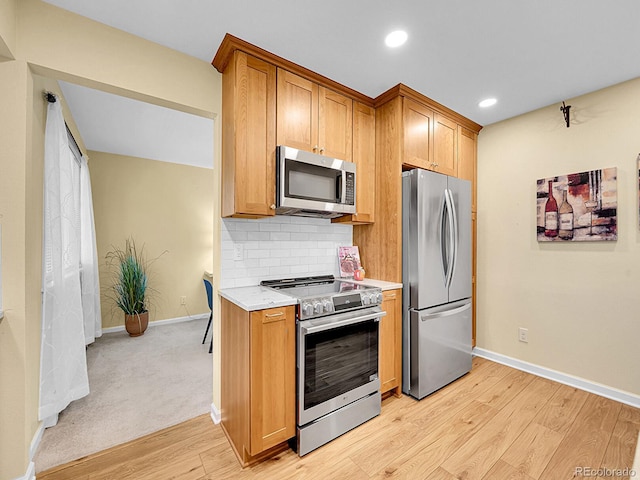 7168 S Lafayette Way, Centennial, CO 80122 - kitchen with appliances with stainless steel finishes, light countertops, light wood finished floors, backsplash, and recessed lighting