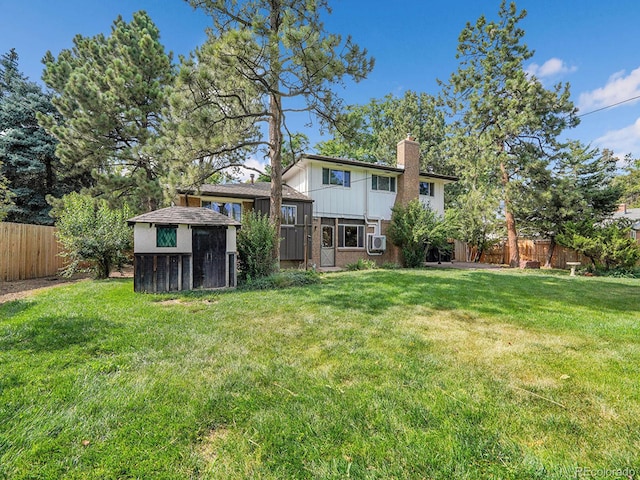 7168 S Lafayette Way, Centennial, CO 80122 - rear view of property featuring a chimney, a fenced backyard, a storage shed, and brick siding