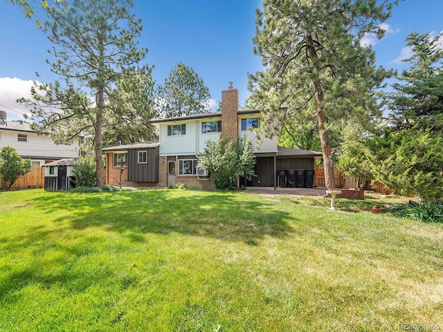 7168 S Lafayette Way, Centennial, CO 80122 - back of house with a chimney and brick siding