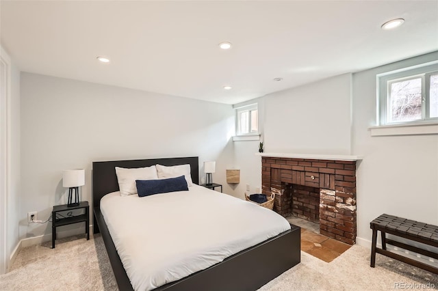 carpeted bedroom with a fireplace, multiple windows, and recessed lighting