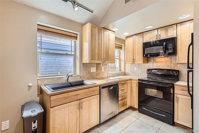 kitchen with light brown cabinets, tasteful backsplash, tile counters, a sink, and black appliances