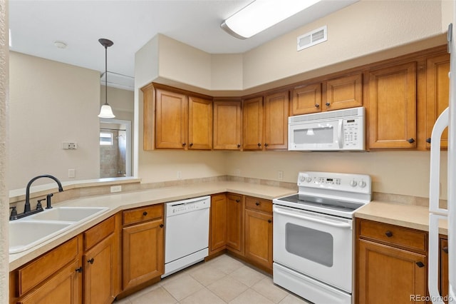 1965 Montura Vw Unit 204, Colorado Springs, CO 80919 - kitchen with a sink, brown cabinetry, and white appliances