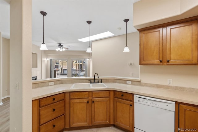 1965 Montura Vw Unit 204, Colorado Springs, CO 80919 - kitchen featuring decorative light fixtures, dishwasher, a sink, a peninsula, and a skylight