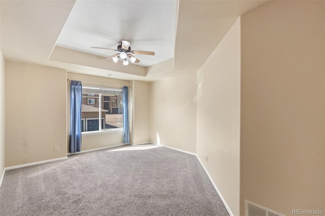 1965 Montura Vw Unit 204, Colorado Springs, CO 80919 - carpeted spare room with visible vents, baseboards, a ceiling fan, and a raised ceiling