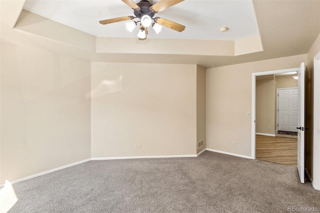1965 Montura Vw Unit 204, Colorado Springs, CO 80919 - carpeted empty room with visible vents, baseboards, a ceiling fan, and a tray ceiling