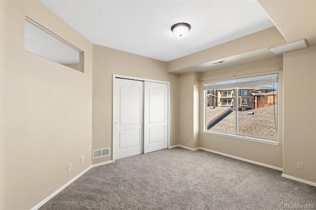 1965 Montura Vw Unit 204, Colorado Springs, CO 80919 - unfurnished bedroom featuring visible vents, baseboards, a closet, and carpet