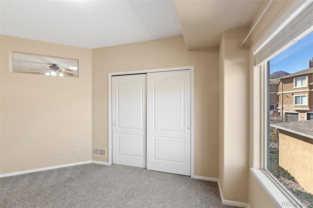 1965 Montura Vw Unit 204, Colorado Springs, CO 80919 - unfurnished bedroom featuring carpet, a closet, visible vents, multiple windows, and baseboards