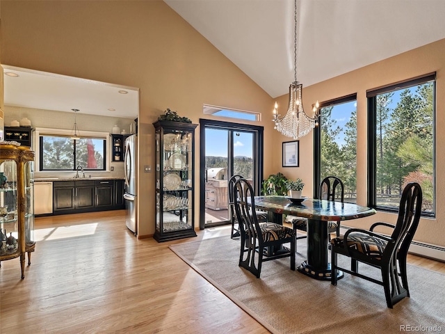 31518 Niakwa Rd, Evergreen, CO 80439 - dining room with a chandelier, light wood-style floors, and high vaulted ceiling