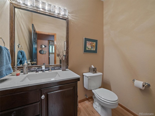 31518 Niakwa Rd, Evergreen, CO 80439 - bathroom featuring toilet, wood finished floors, vanity, and baseboards