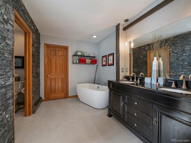 31518 Niakwa Rd, Evergreen, CO 80439 - bathroom with double vanity, a freestanding bath, toilet, and tile patterned floors