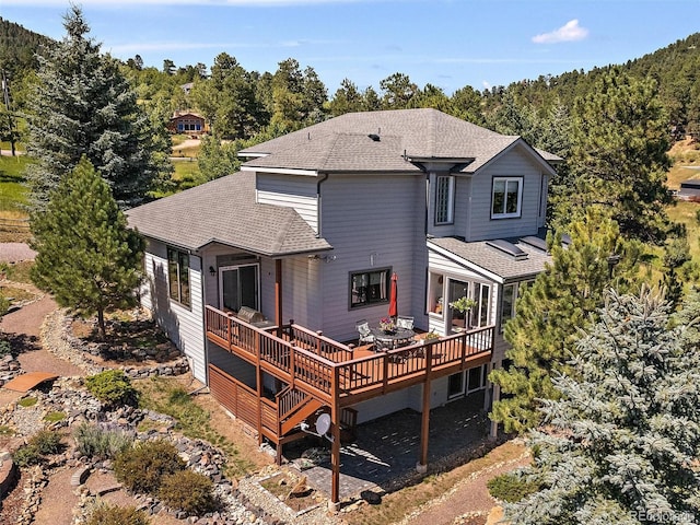 31518 Niakwa Rd, Evergreen, CO 80439 - rear view of house featuring a shingled roof and a deck