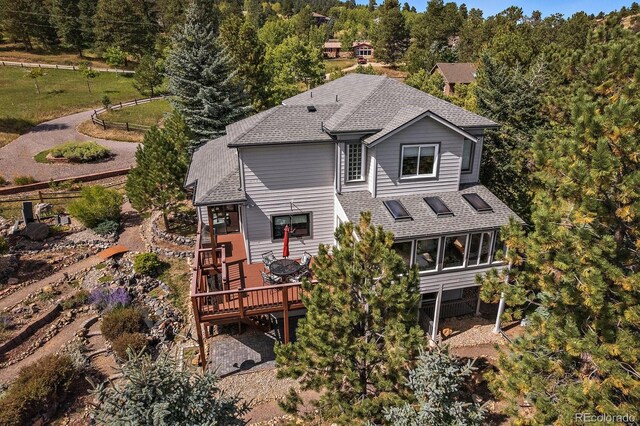 31518 Niakwa Rd, Evergreen, CO 80439 - rear view of house with a shingled roof and a wooden deck