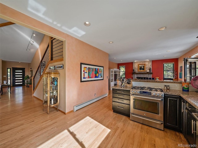 31518 Niakwa Rd, Evergreen, CO 80439 - kitchen featuring gas range, a baseboard heating unit, light wood-style flooring, recessed lighting, and stone countertops