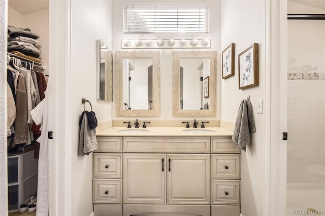 bathroom with vanity and a tile shower