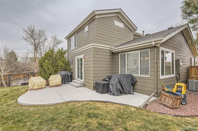 back of property with a lawn, cooling unit, and a patio