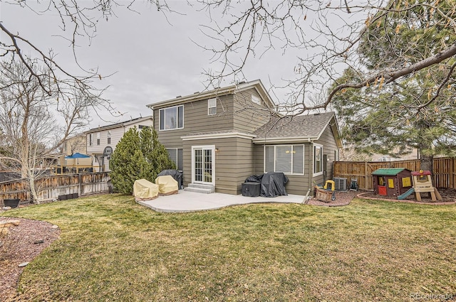 back of house with a patio area and a yard