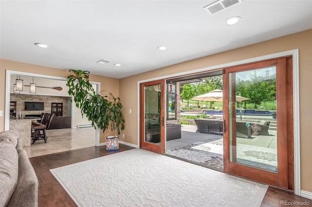 5727 Colorow Dr, Morrison, CO 80465 - entryway with dark wood finished floors, recessed lighting, baseboards, and a fireplace