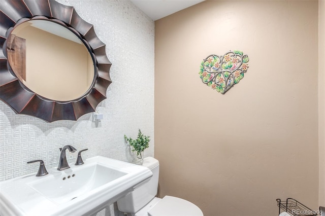 5727 Colorow Dr, Morrison, CO 80465 - half bath featuring a sink, toilet, and tasteful backsplash