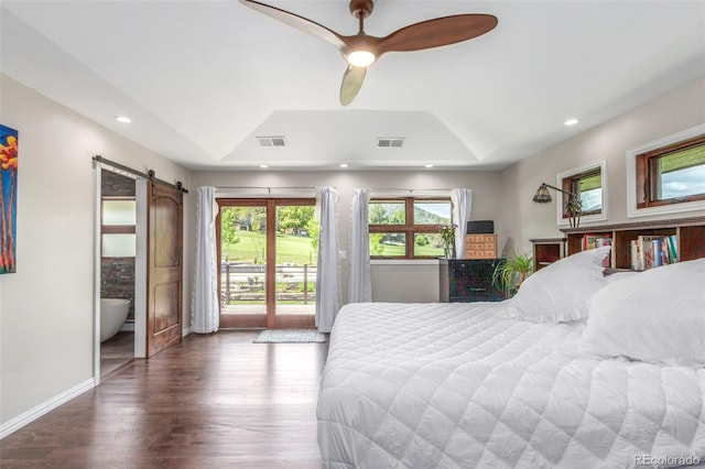 5727 Colorow Dr, Morrison, CO 80465 - bedroom with a tray ceiling, a barn door, access to outside, wood finished floors, and recessed lighting