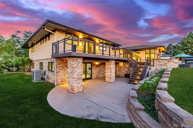 5727 Colorow Dr, Morrison, CO 80465 - back of house at dusk with central AC unit, a yard, a patio area, and stairs