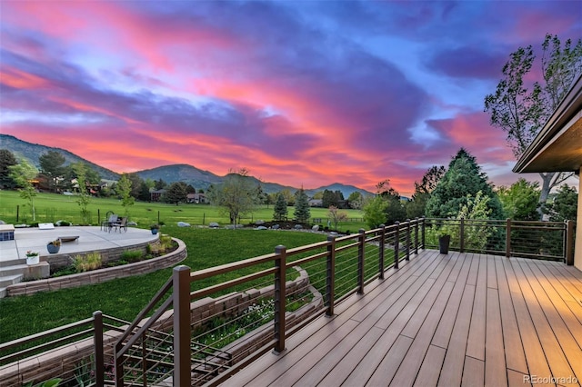 5727 Colorow Dr, Morrison, CO 80465 - deck featuring a mountain view, a patio area, and a lawn