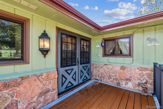 doorway to property featuring stone siding