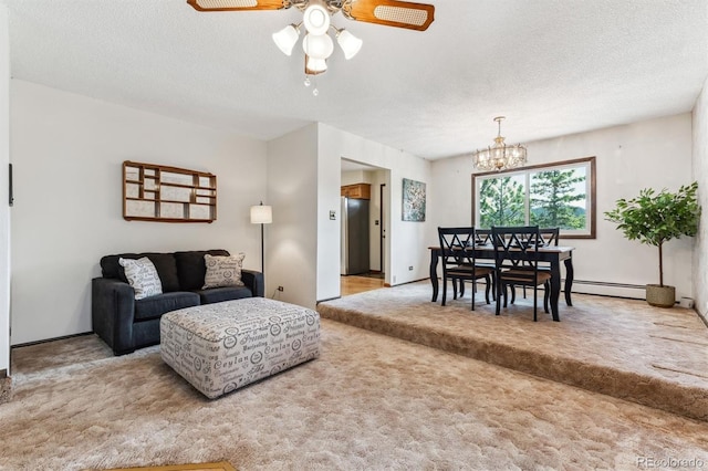 carpeted living area featuring baseboard heating, ceiling fan with notable chandelier, and a textured ceiling