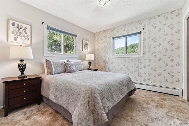 bedroom featuring light colored carpet, a baseboard radiator, a textured ceiling, and wallpapered walls