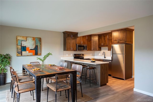 1153 Straight Creek Dr Unit F102, Dillon, CO 80435 - kitchen featuring stainless steel appliances, a sink, light wood finished floors, and light countertops